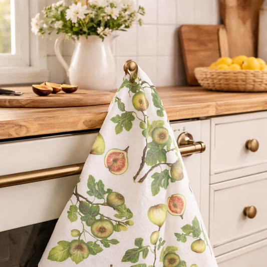 Kitchen towel with fruit design hanging on a stove handle